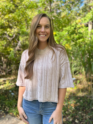 Woman in a stone washed cable knit short sleeve sweater with jeans | V-Rae's Boutique