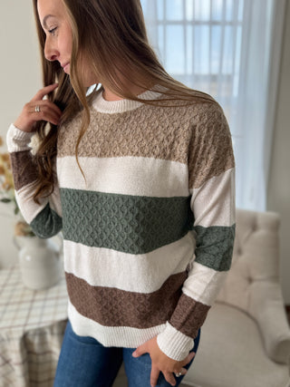 Woman wearing a striped sweater in a home setting