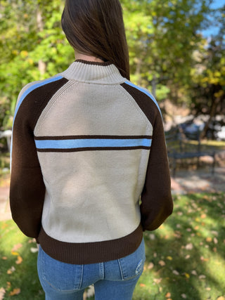 Back view of a cream and brown retro stripe zip-up sweater | V-Rae's Boutique