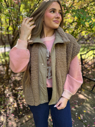 Woman in a taupe sherpa oversized vest over a pink sweater | V-Rae's Boutique