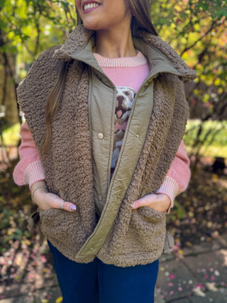 Close-up of a taupe sherpa vest with hands in pockets | V-Rae's Boutique