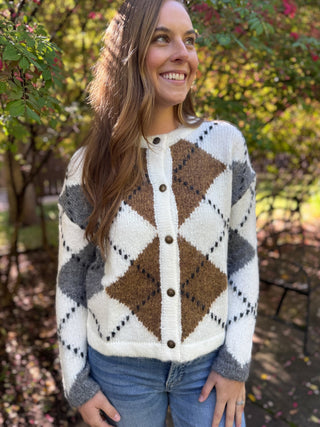 Woman in a cream and brown argyle fuzzy button-front knit sweater | V-Rae's Boutique
