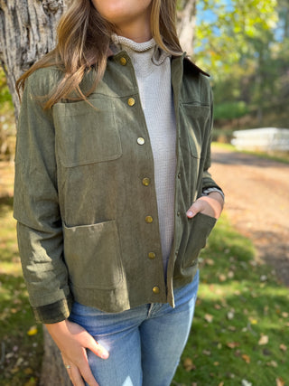 Olive corduroy barn jacket worn over a cream turtleneck | V-Rae's Boutique