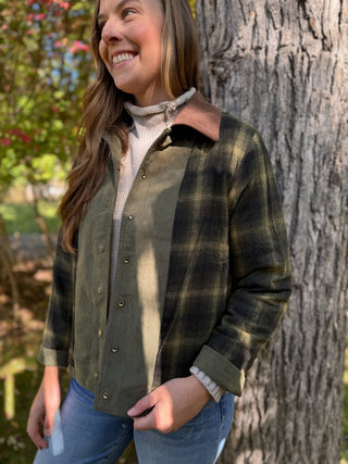 Olive and plaid barn jacket worn over a cream turtleneck | V-Rae's Boutique