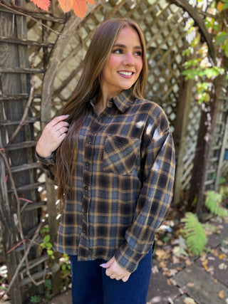 Woman in a navy and gold plaid flannel shirt with dark jeans | V-Rae's Boutique