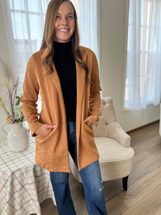 Woman wearing a brown cardigan in a home setting