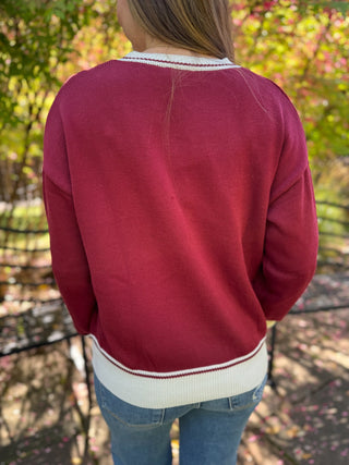 Back view of a burgundy equestrian knit sweater with cream trim | V-Rae's Boutique