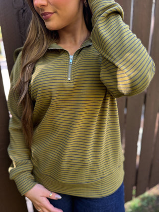 Close-up of the zipper and stripes on an olive quarter-zip pullover | V-Rae's Boutique