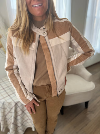Person wearing a brown and beige checkered jacket indoors