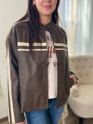 Person wearing a brown jacket with white stripes indoors