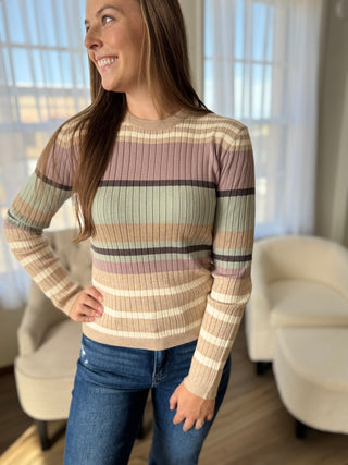 Woman wearing a striped sweater in a living room setting