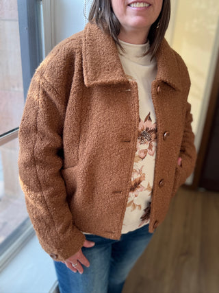 Person wearing a brown fleece jacket indoors