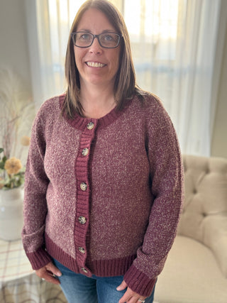 Woman wearing a maroon cardigan with buttons indoors