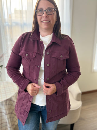 Woman wearing a purple jacket indoors