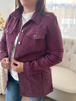 Person wearing a purple denim jacket indoors