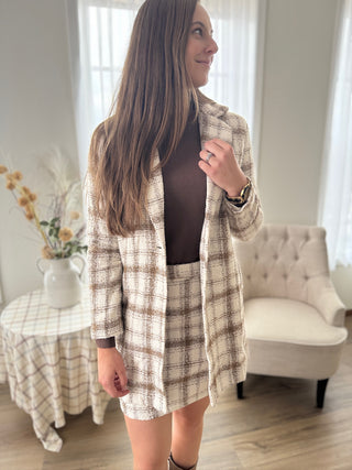 Woman wearing a plaid outfit in a living room setting