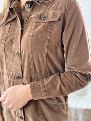 Close-up of a brown button-up shirt with a blurred background