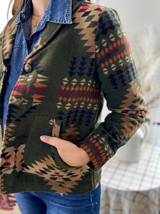 Person wearing a patterned jacket with a blurred background
