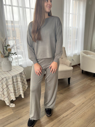 Woman wearing a gray outfit in a living room setting