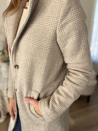 Plaid coat worn by a person with a blurred background