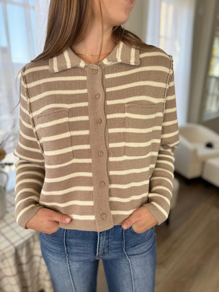 Photo of a woman in a striped sweater.