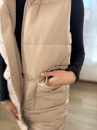 Beige puffer vest worn by a person with a blurred background