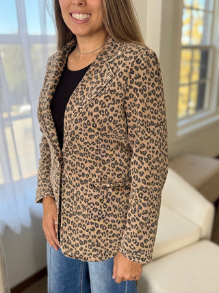 Woman wearing a leopard print jacket indoors