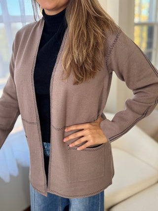 Photo of a woman in a taupe knit cardigan.