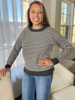 Woman wearing a black and white checkered sweater in a living room setting