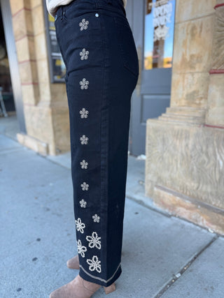 Side view of black floral embroidered wide leg jeans | V-Rae's Boutique
