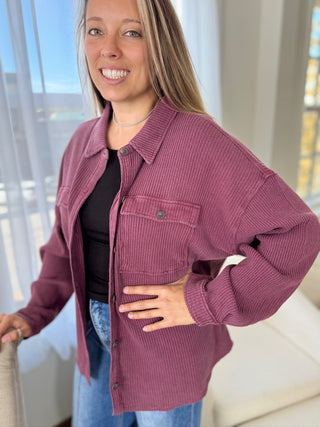 Woman wearing a purple corduroy jacket indoors