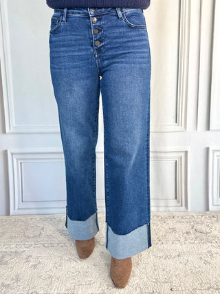 Blue jeans with a white wall background