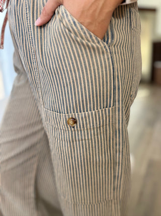 Close-up of a person wearing striped pants with a blurred background