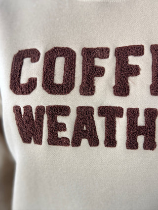 Text 'COFFEE WEATHER' on a textured surface