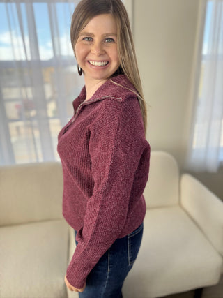 Woman wearing a maroon sweater in a living room setting
