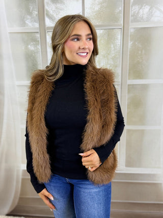 Brown faux fur vest over a black turtleneck | V-Rae's Boutique