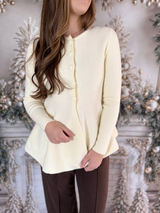 Photo of a woman in a cream knit sweater