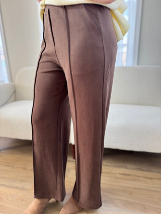 Photo of a woman in brown pants