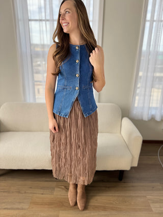 Woman in a brown crinkle mesh skirt.