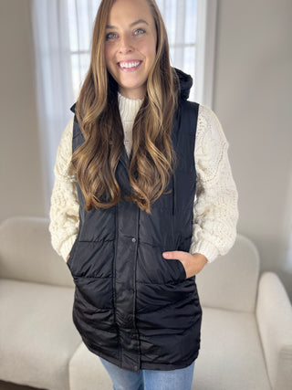 Photo of a woman in a long vest.