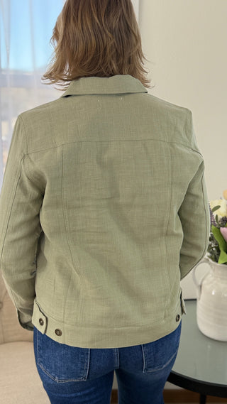 Person wearing a green jacket in an indoor setting