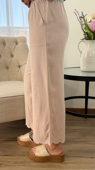 Person wearing beige pants standing in a living room.