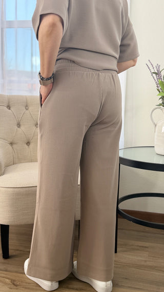 Person wearing beige pants in a living room setting