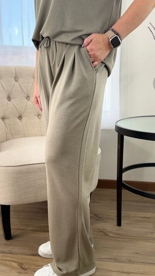 Person wearing beige lounge pants in a living room setting