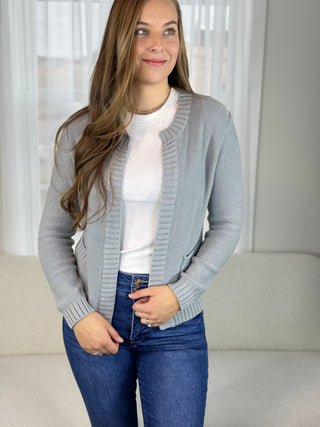 Woman in a slate blue cardigan.