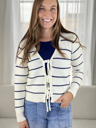 Woman wearing a striped cardigan with a blurred background