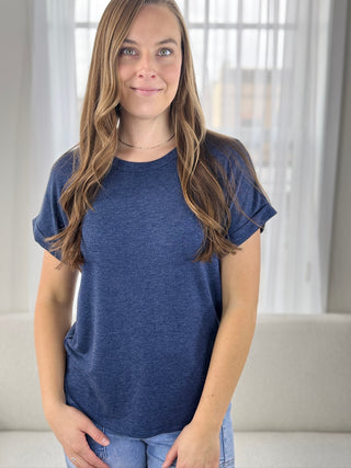 Woman wearing a blue t-shirt in a bright room
