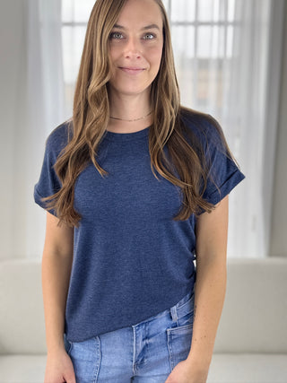 Woman wearing a blue t-shirt and jeans indoors