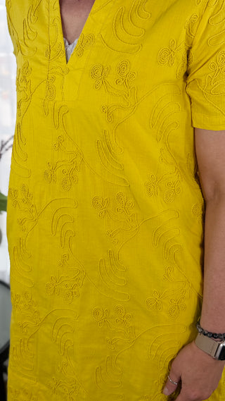 Yellow embroidered garment with intricate patterns