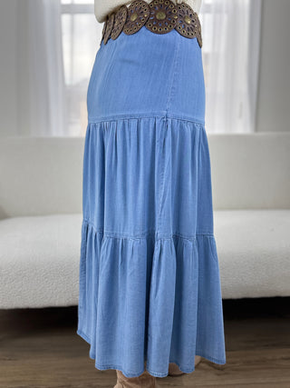 Blue denim dress with a decorative belt worn by a person indoors.